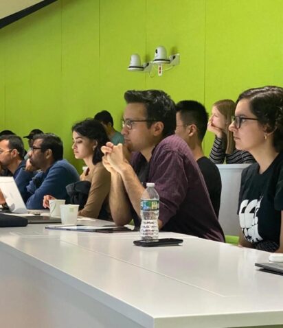 Students listen intently at a lecture.