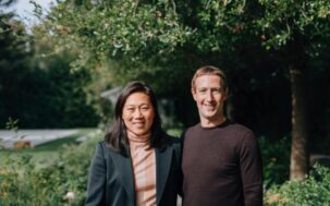 Priscilla Chan and Mark Zuckerberg standing side by side, smiling