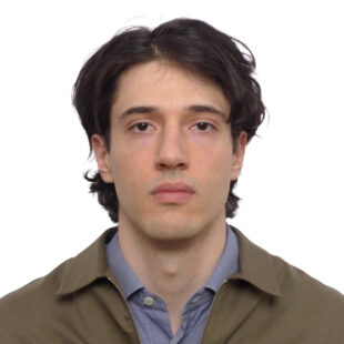 Thomas Wyndham bush, wearing a blue collared shirt and a brown jacket, looking at the camera.