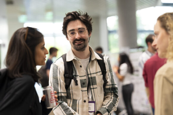A man in conversation smiling at the camera